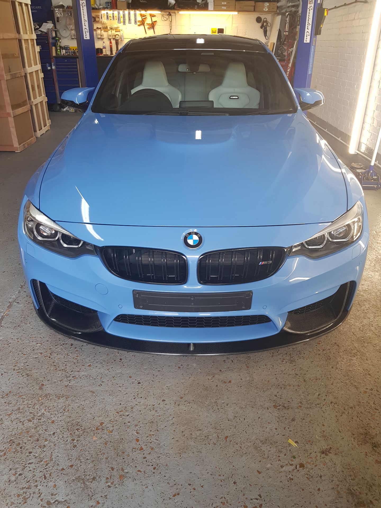 A BMW M car inside Prime Motive's workshop during a vehicle security installation