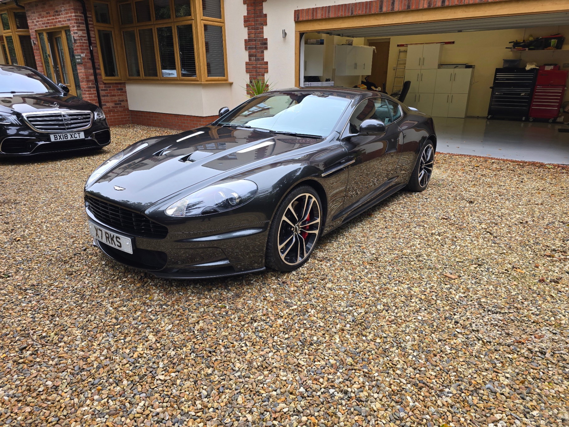 Grey Aston Martin DBS on a private driveway