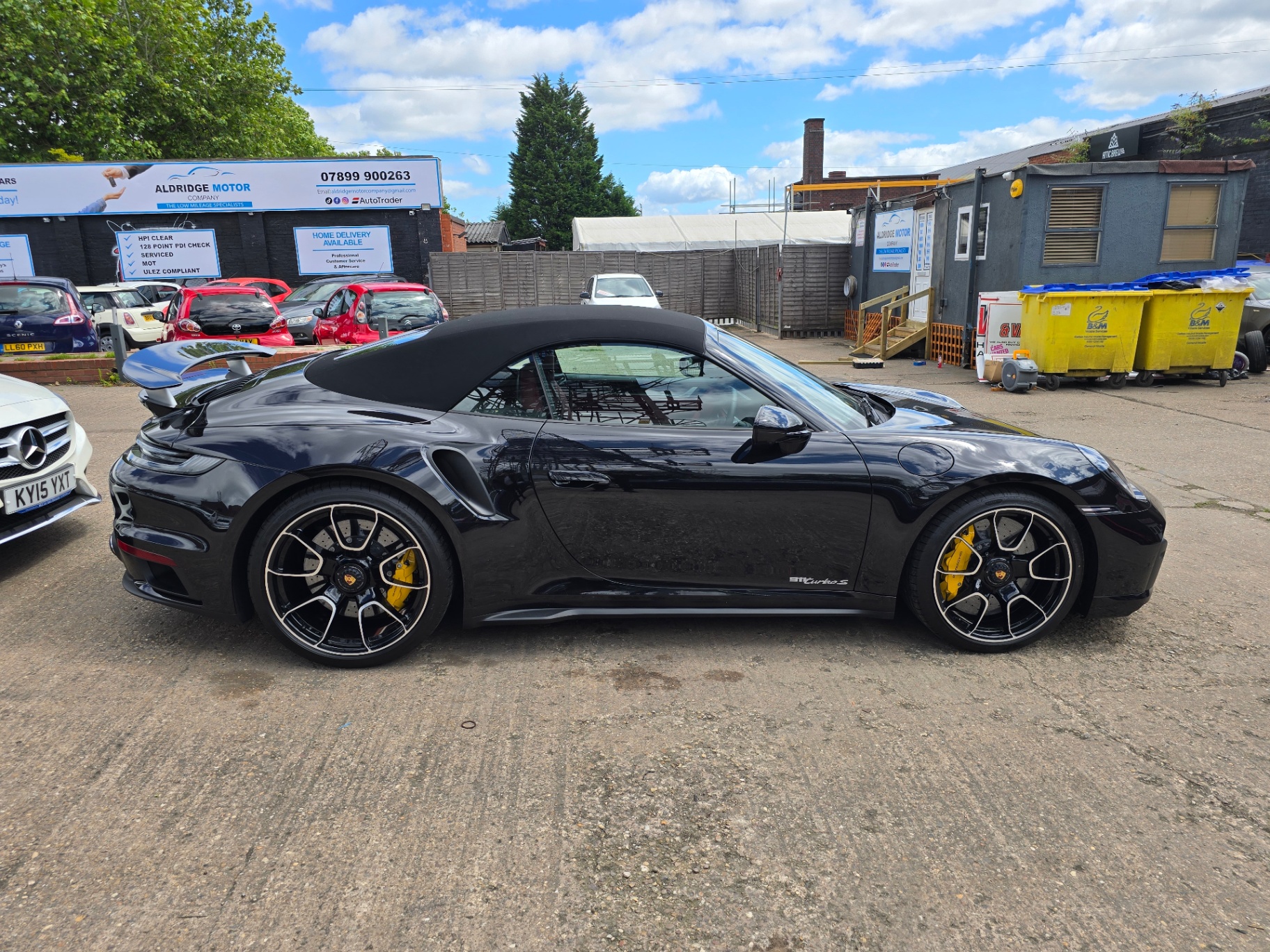 Side profile of a black Porsche 911 Turbo S protected by Prime Motive