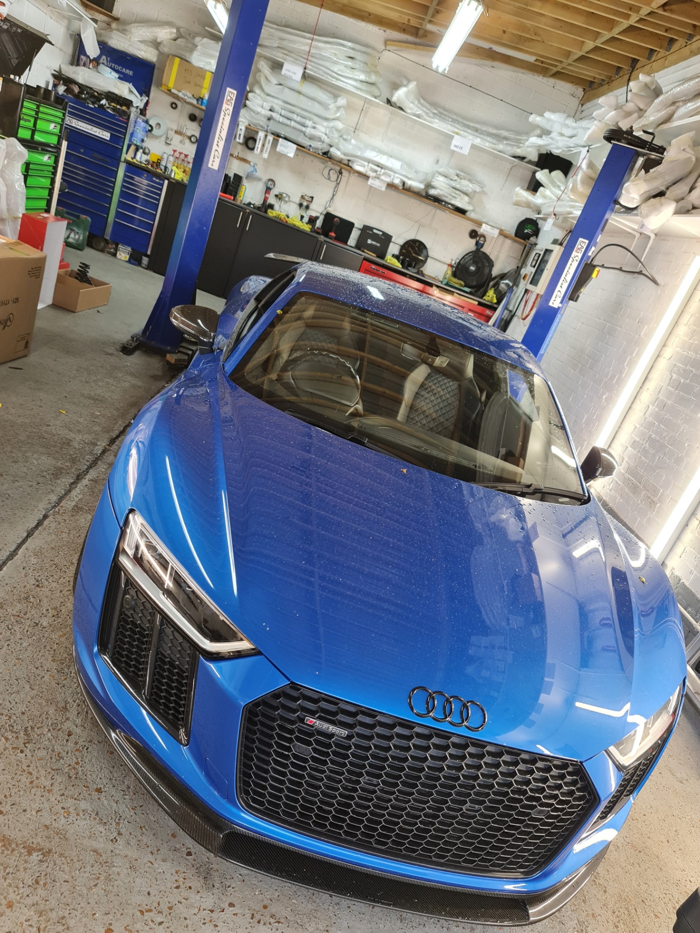 Blue Audi R8 in the workshop for Prime Motive security install